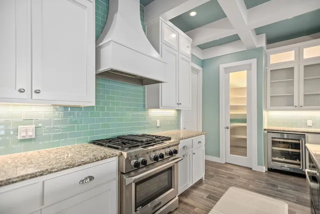 a kitchen with stainless steel appliances granite countertop a stove and a sink