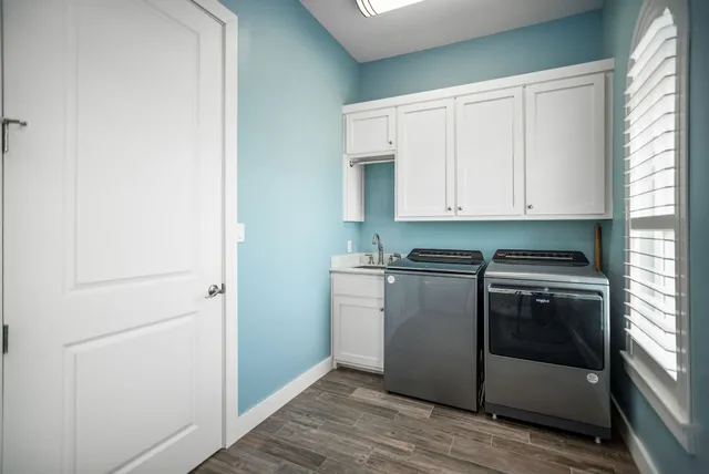 a kitchen with windows and refrigerator