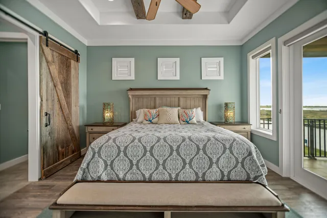 a bedroom with a bed and a flat tv screen on dresser