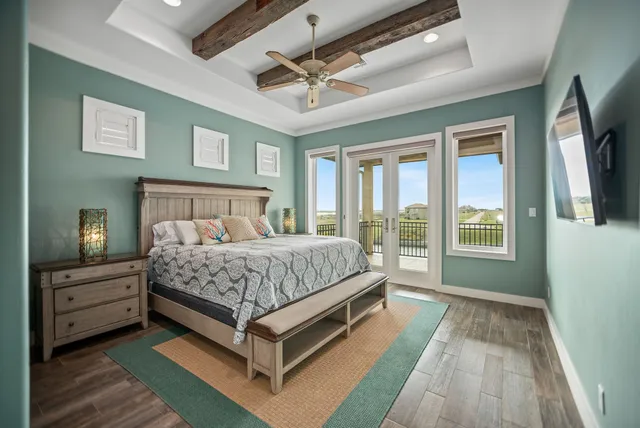 a bedroom with a bed and a chandelier