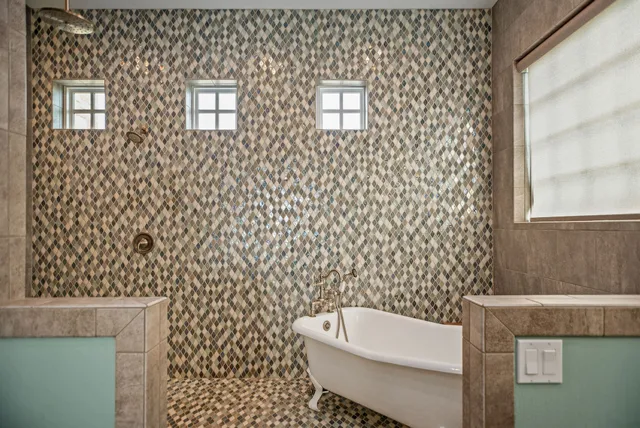 a spacious bathroom with a double vanity sink a large mirror and a bathtub