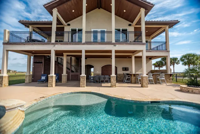 a view of a building with sitting area and swimming pool