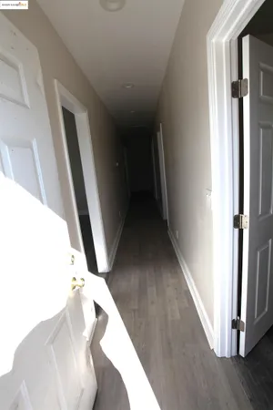 an empty room with wooden floor and closet