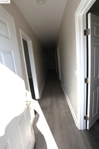 an empty room with wooden floor and closet