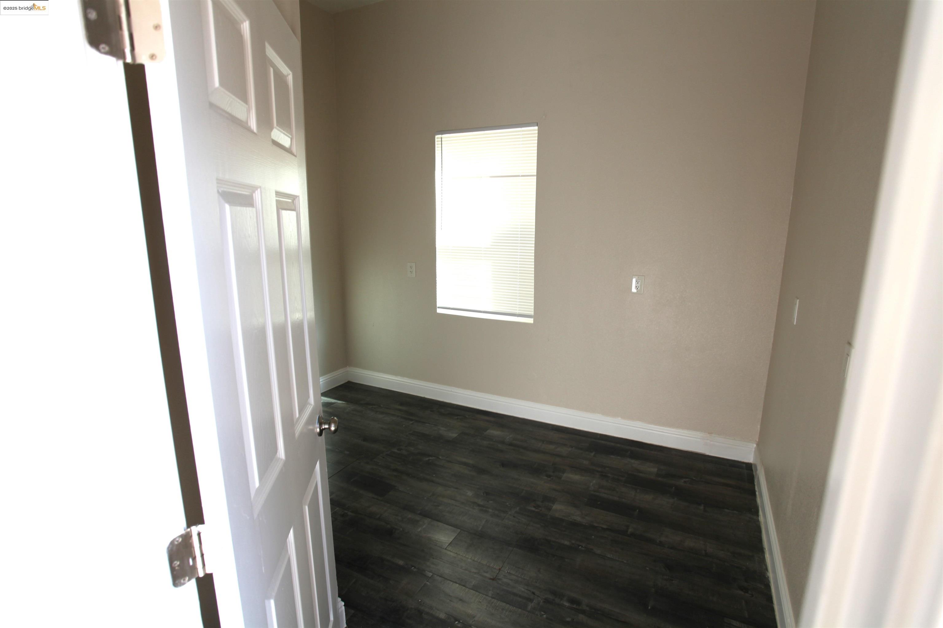50 Main Street Isleton, CA 95641 - Photo 13 of 59 a view of an empty room with wooden floor and a window