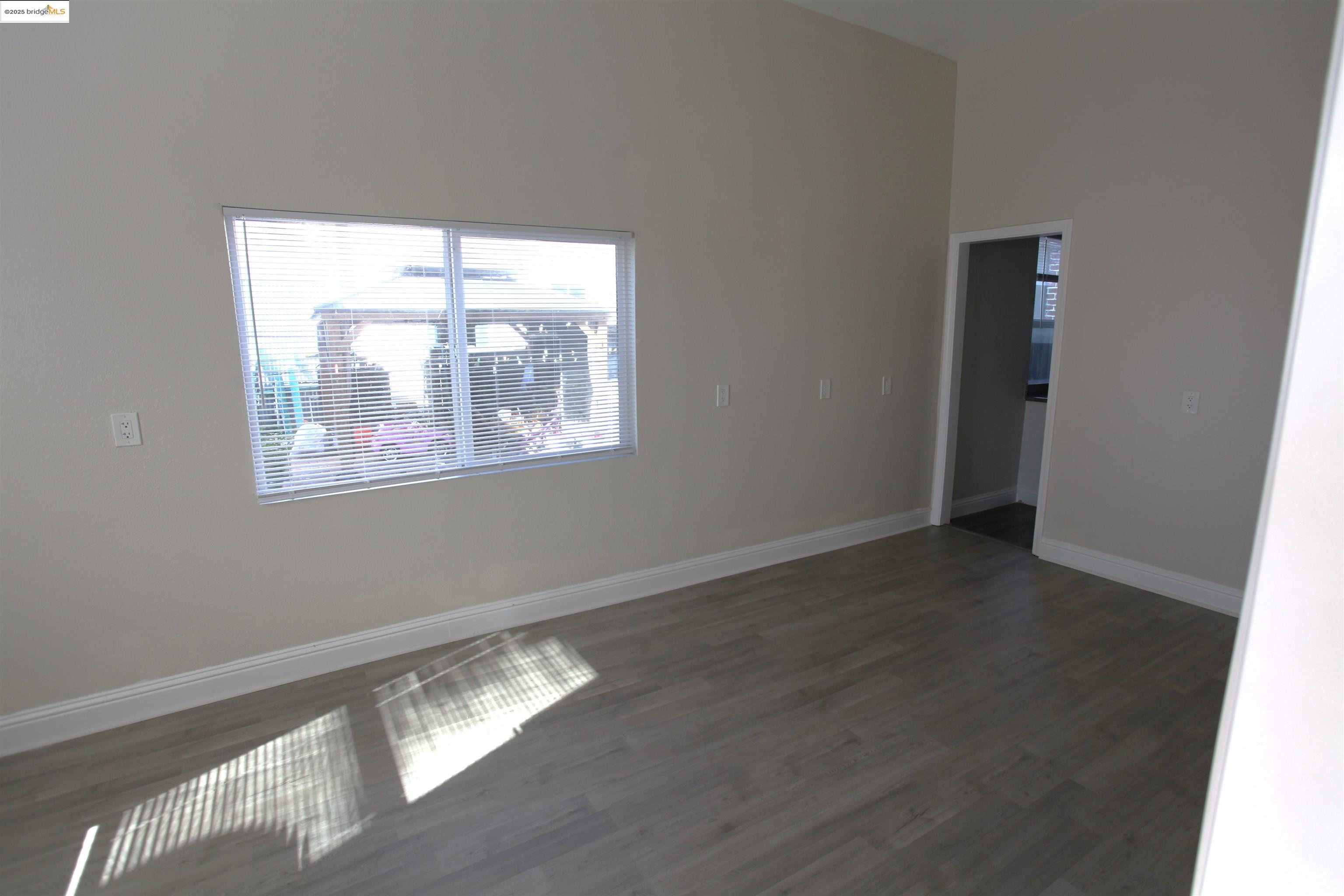 50 Main Street Isleton, CA 95641 - Photo 15 of 59 a view of an empty room with wooden floor and a window