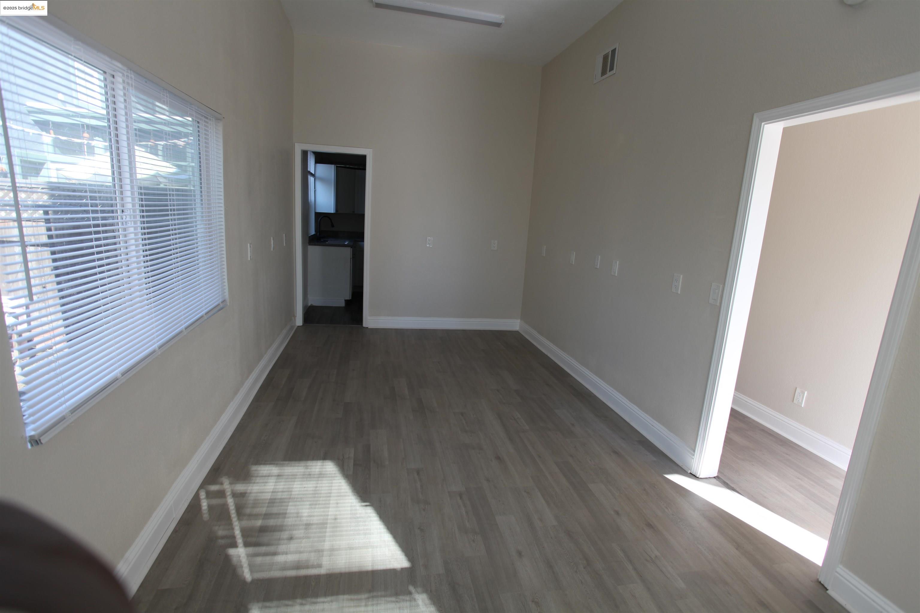 50 Main Street Isleton, CA 95641 - Photo 17 of 59 an entryway in a hall with wooden floor and a window