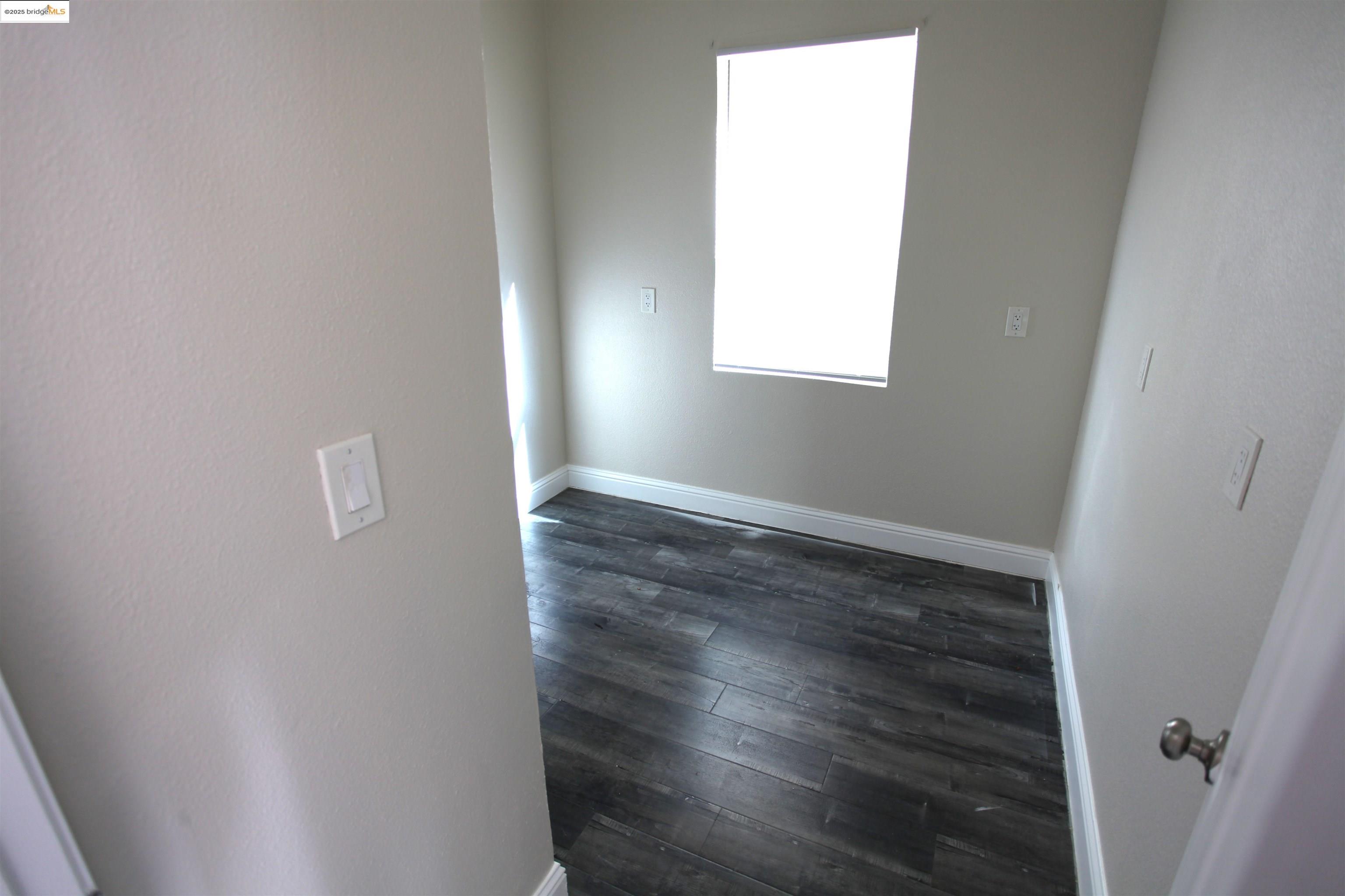 50 Main Street Isleton, CA 95641 - Photo 18 of 59 a view of an empty room with wooden floor and a window