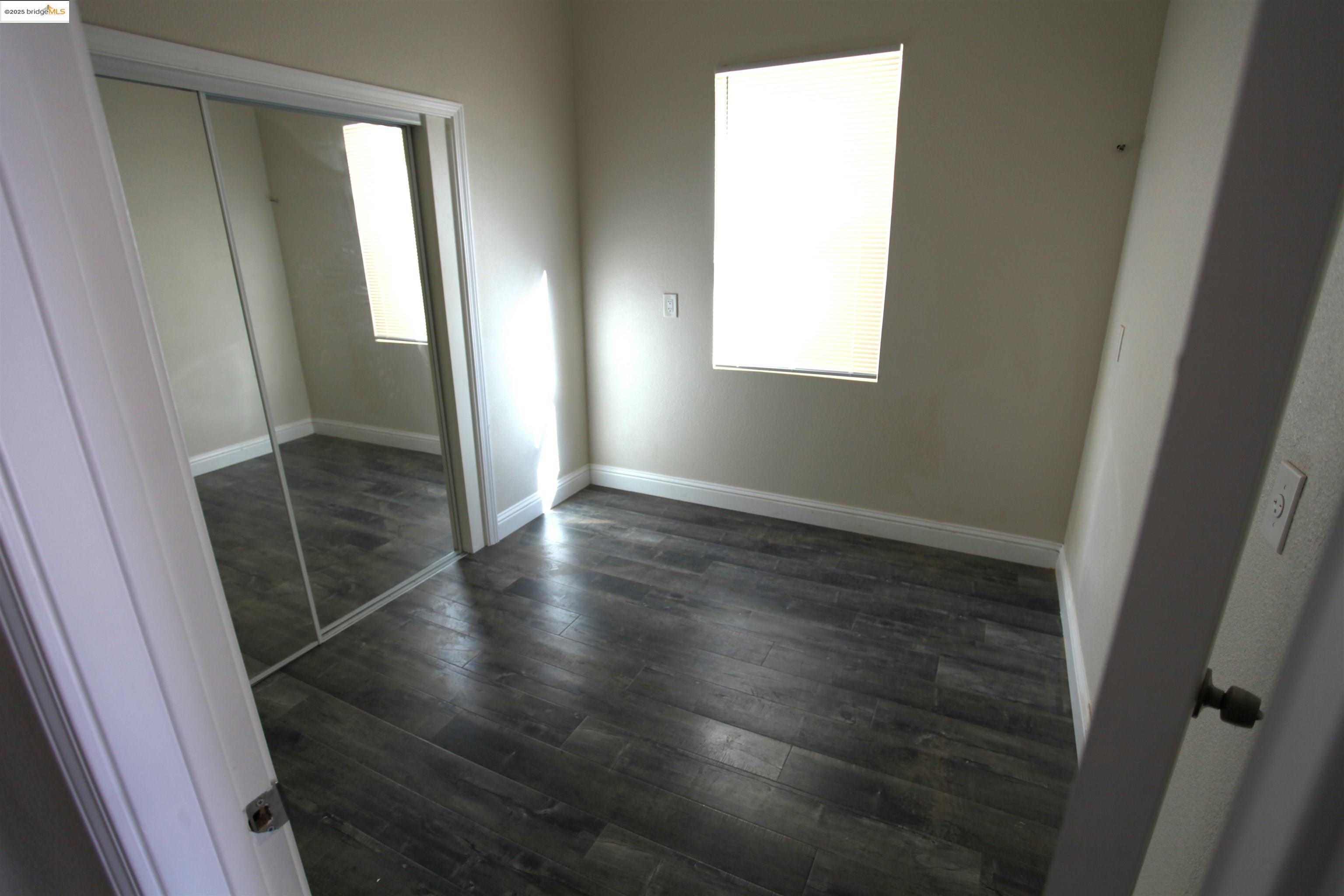 50 Main Street Isleton, CA 95641 - Photo 19 of 59 an empty room with wooden floor and windows