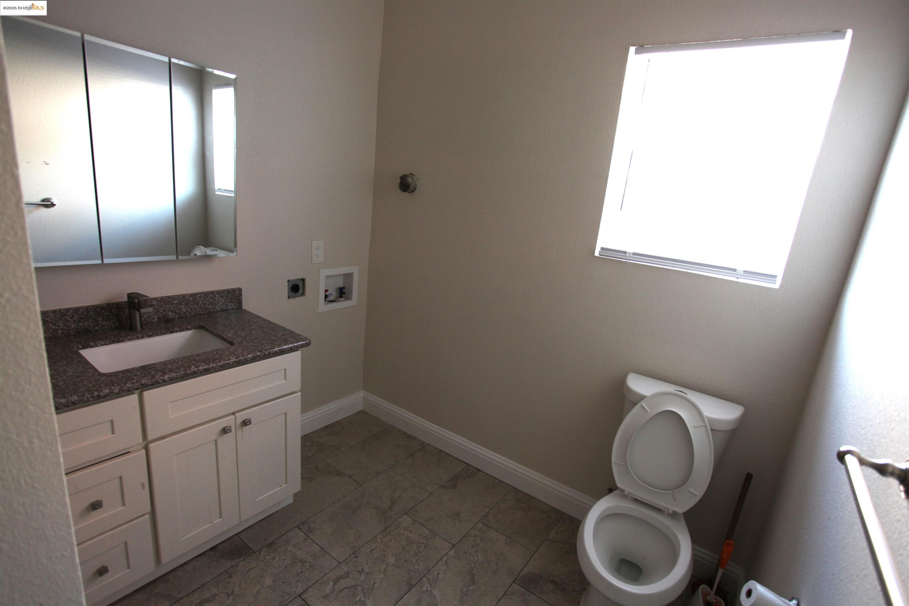 50 Main Street Isleton, CA 95641 - Photo 24 of 59 a bathroom with a toilet sink and mirror