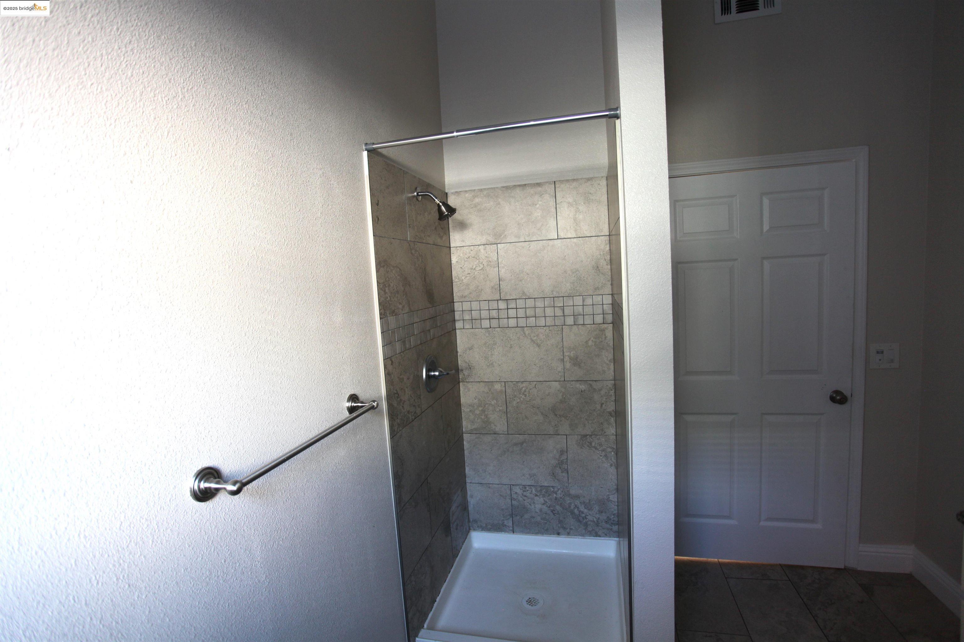 50 Main Street Isleton, CA 95641 - Photo 25 of 59 a bathroom with a glass shower door