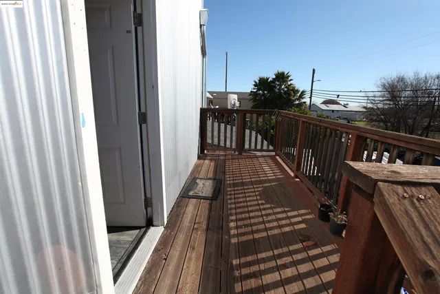 a kitchen with granite countertop wooden floors a stove and white stainless steel appliances
