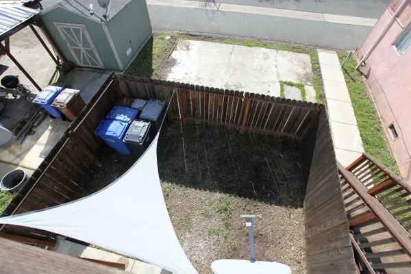 a kitchen with a refrigerator wooden floor and electronic appliances