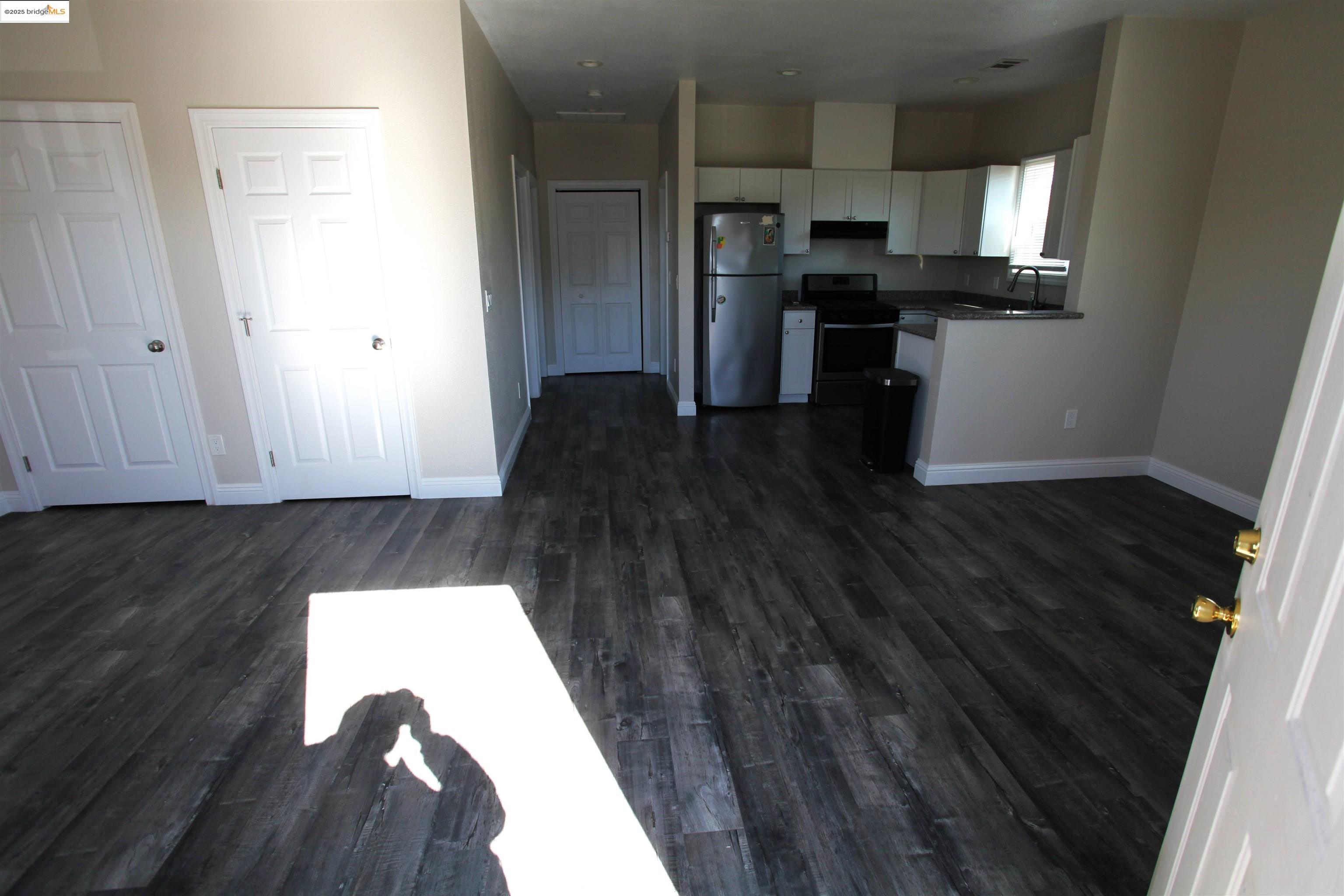 50 Main Street Isleton, CA 95641 - Photo 30 of 59 a kitchen with a wooden floor and a stove top oven