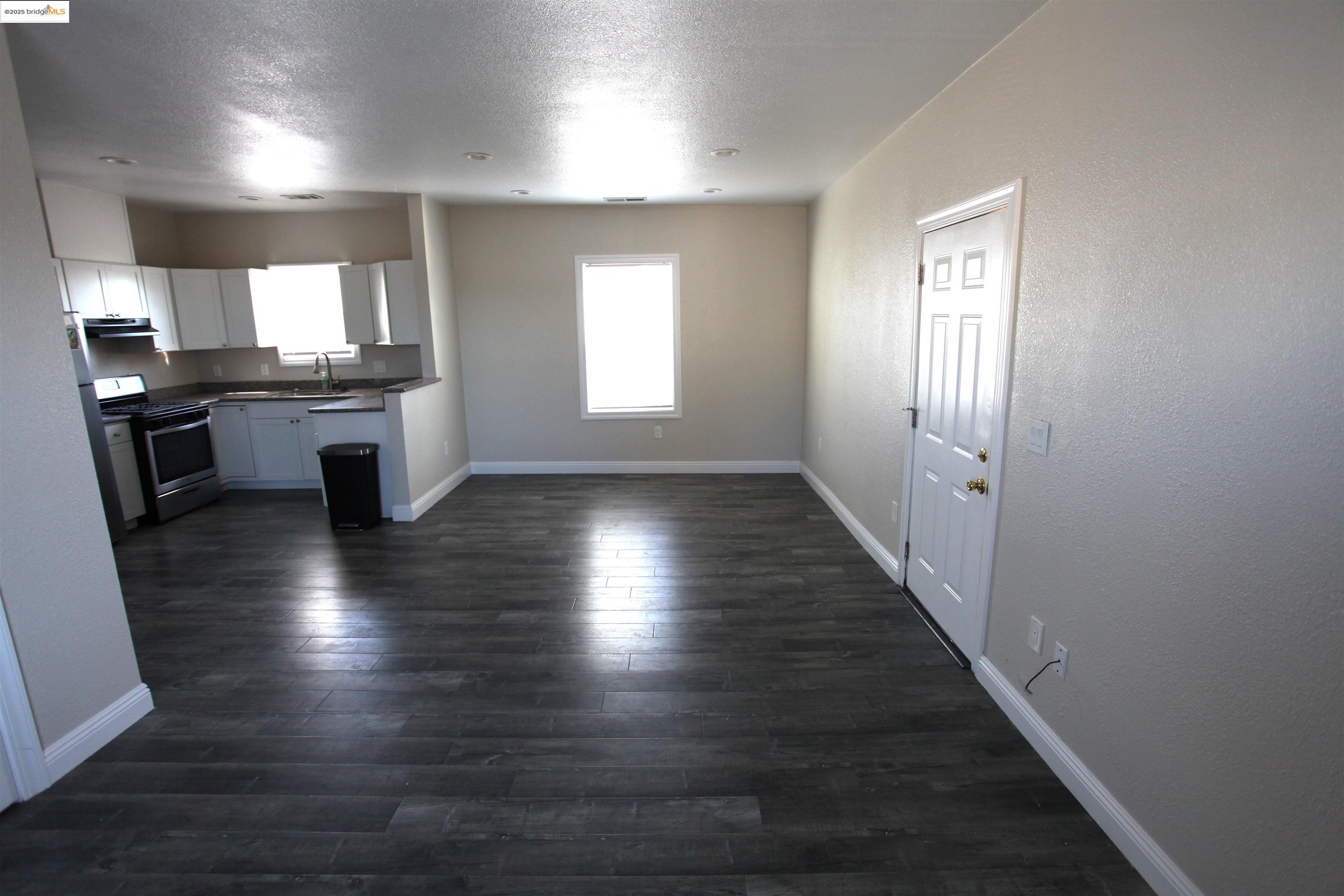 50 Main Street Isleton, CA 95641 - Photo 32 of 59 an empty room with wooden floor and windows