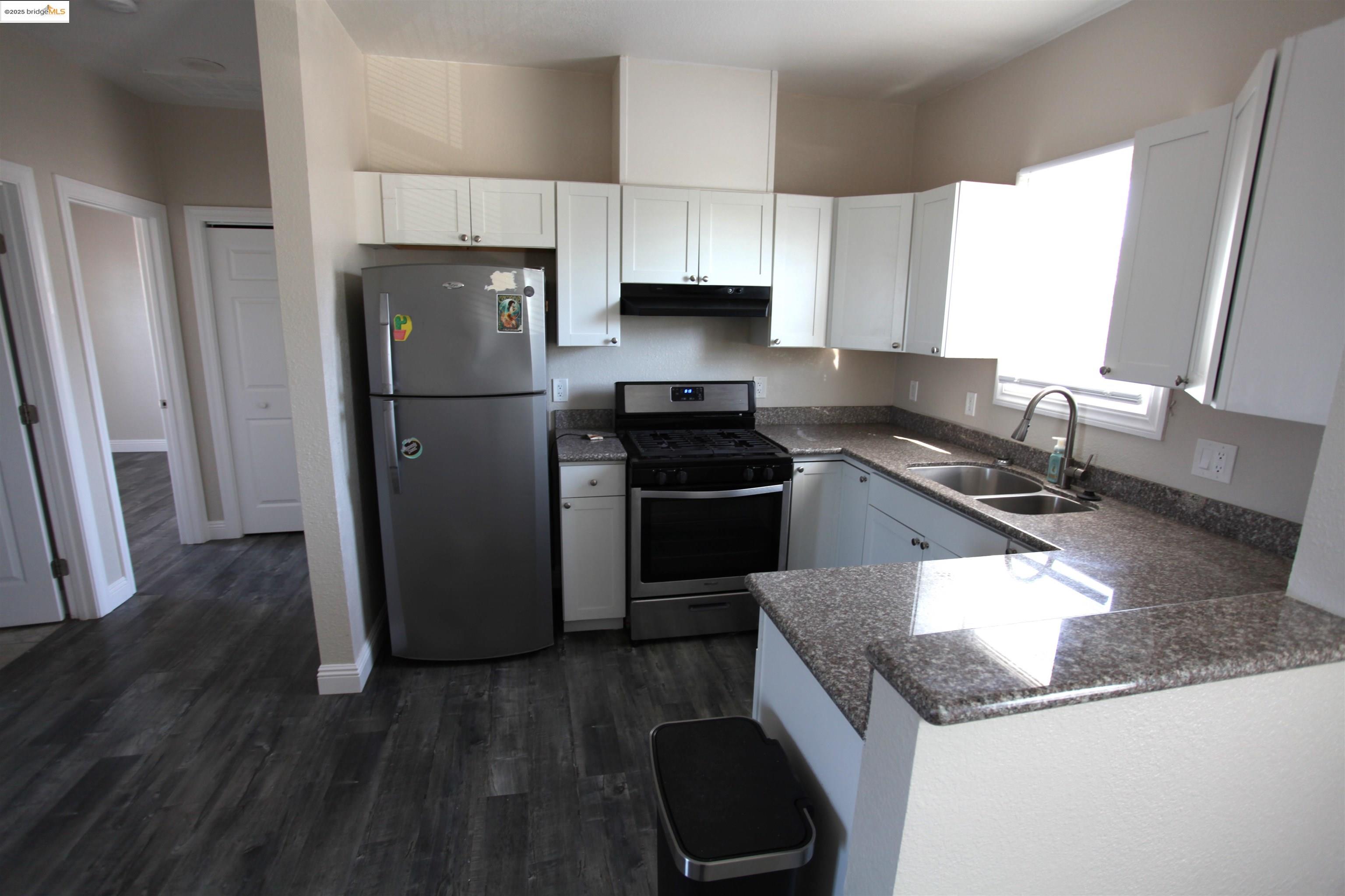 50 Main Street Isleton, CA 95641 - Photo 35 of 59 a kitchen with granite countertop stainless steel appliances a sink a counter space and a window