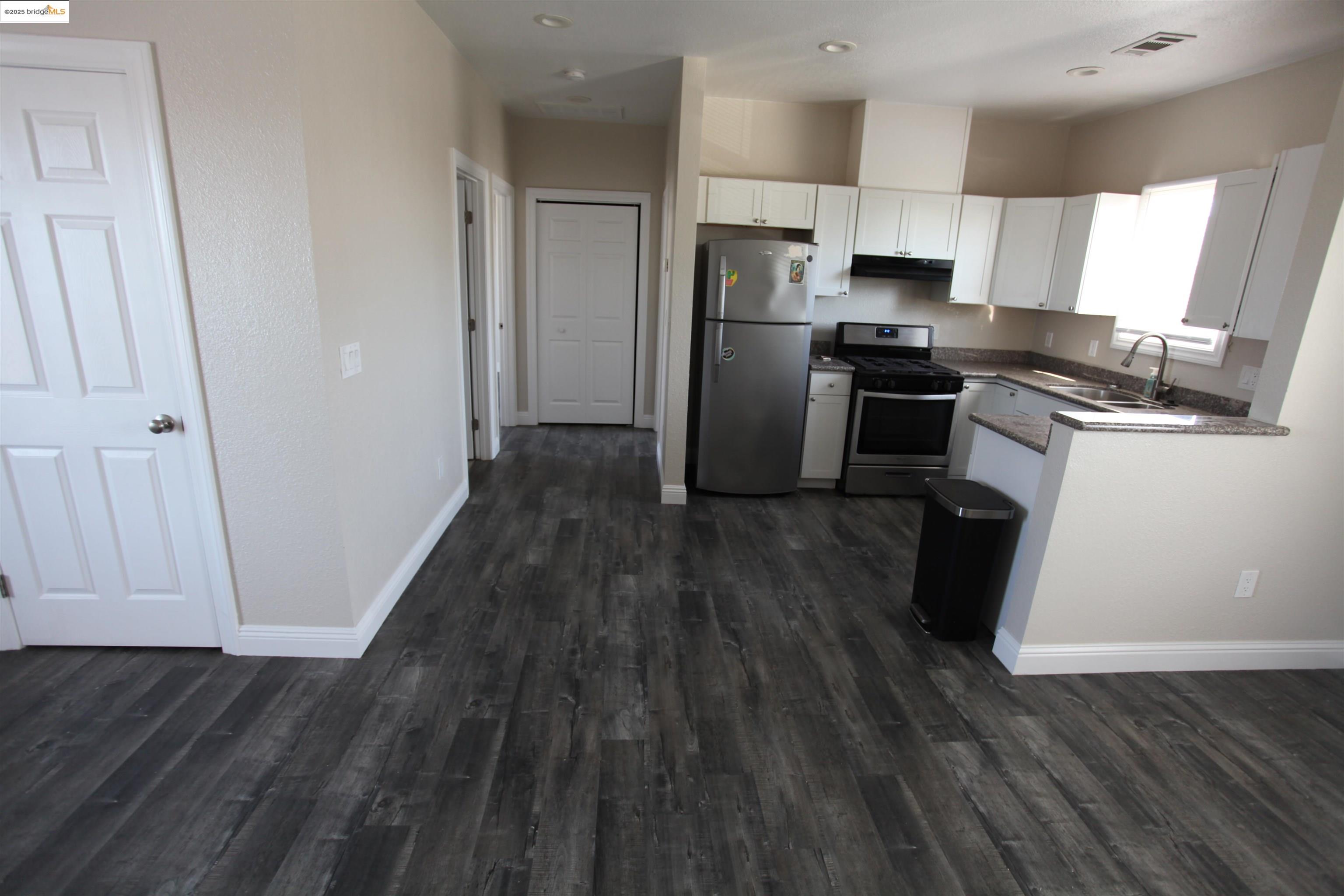 50 Main Street Isleton, CA 95641 - Photo 37 of 59 a kitchen with a refrigerator wooden floor and electronic appliances