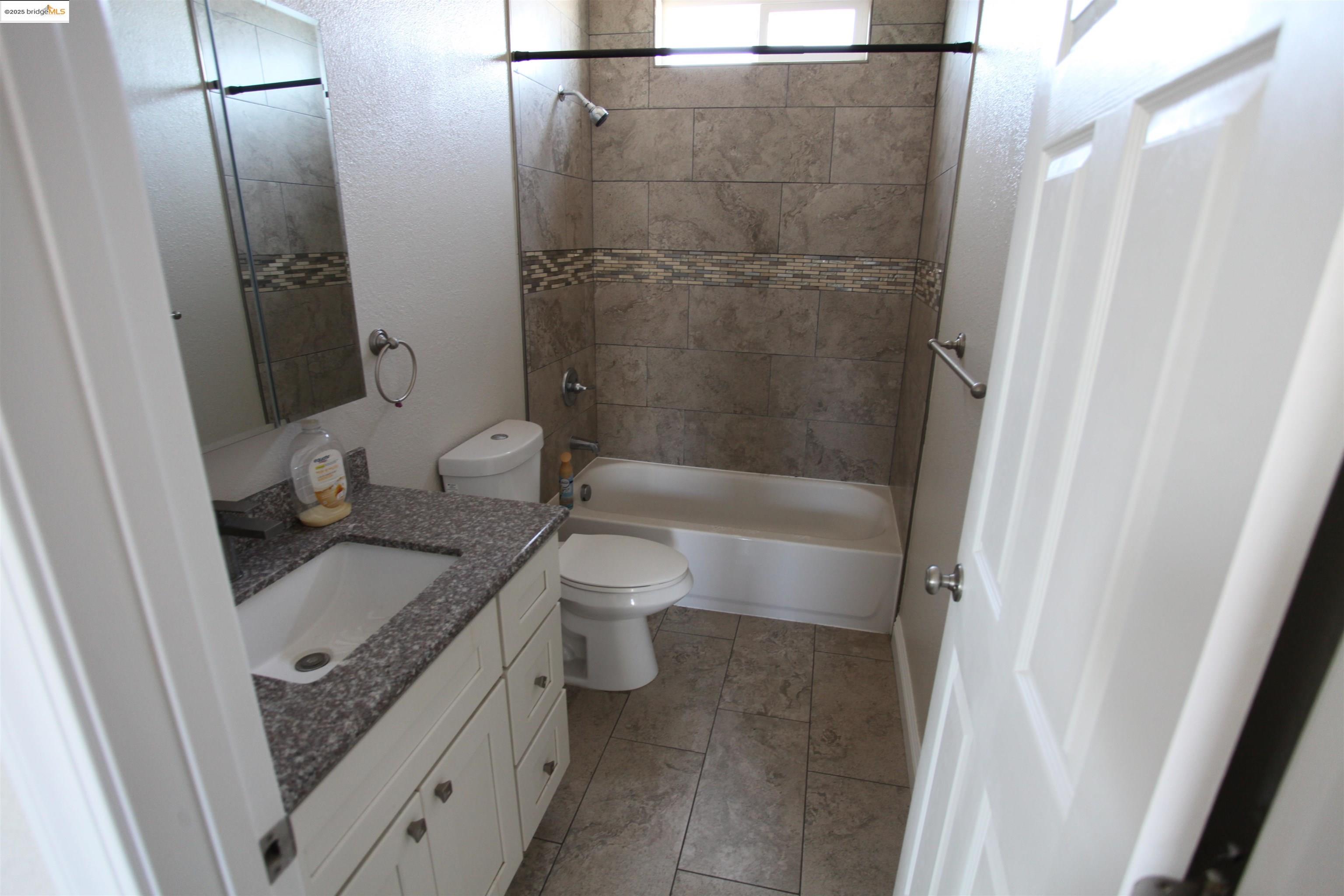 50 Main Street Isleton, CA 95641 - Photo 38 of 59 a bathroom with a granite countertop sink toilet and shower