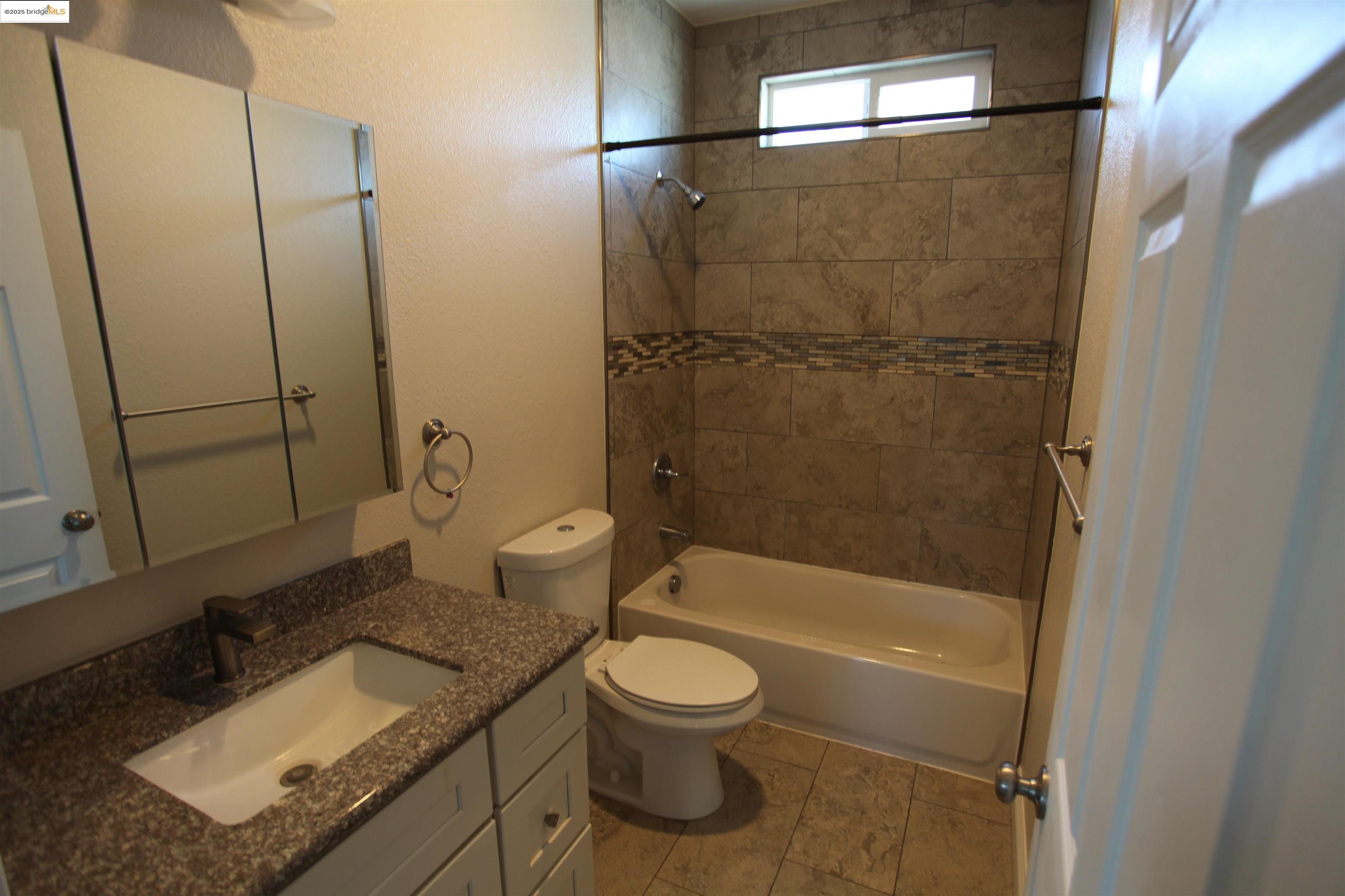 50 Main Street Isleton, CA 95641 - Photo 39 of 59 a bathroom with a granite countertop sink toilet and shower