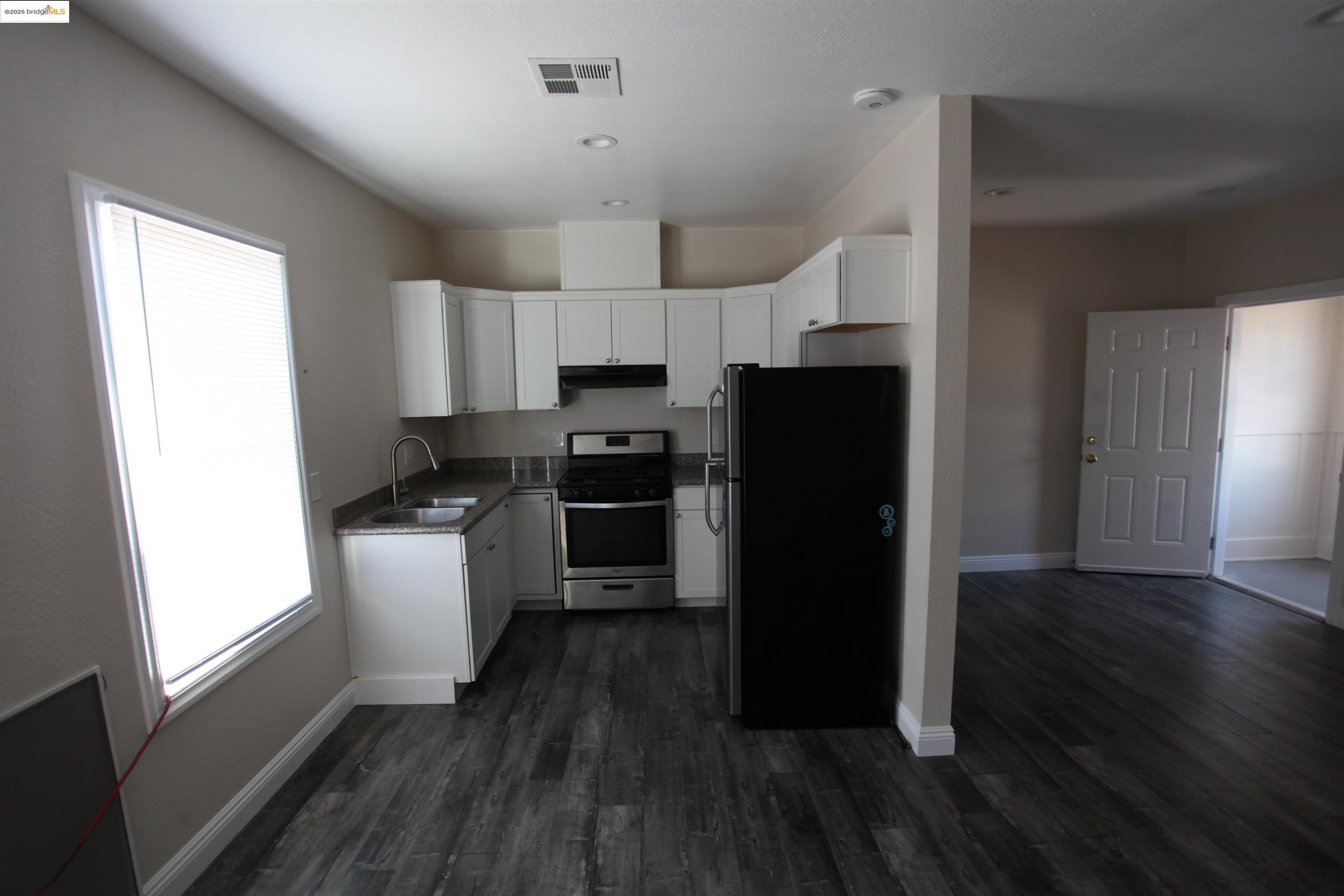 50 Main Street Isleton, CA 95641 - Photo 45 of 59 a kitchen with a refrigerator and a stove top oven