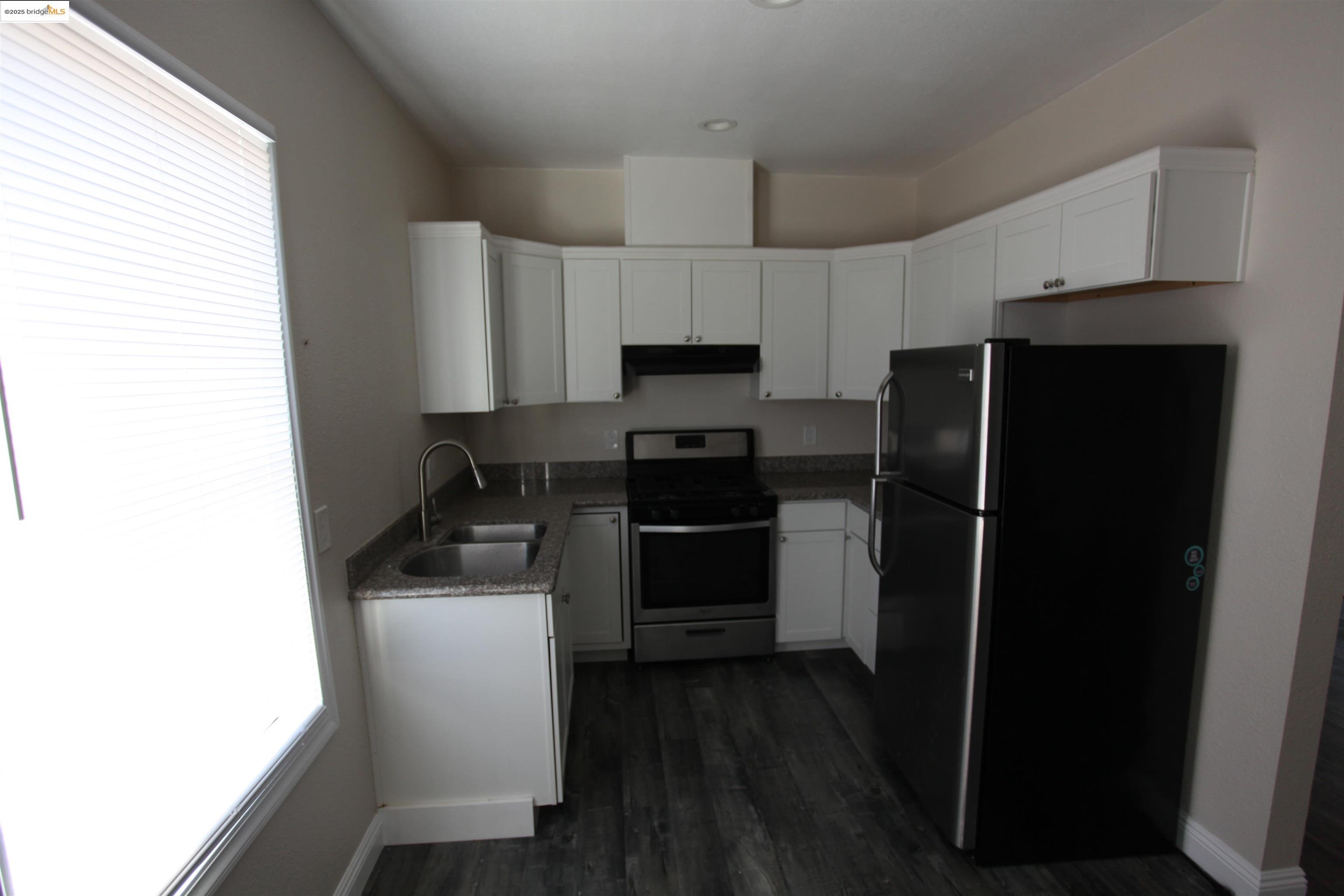 50 Main Street Isleton, CA 95641 - Photo 46 of 59 a kitchen with a refrigerator stove and sink