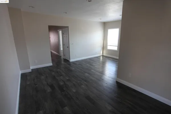 a view of a hallway with wooden floor and glass door