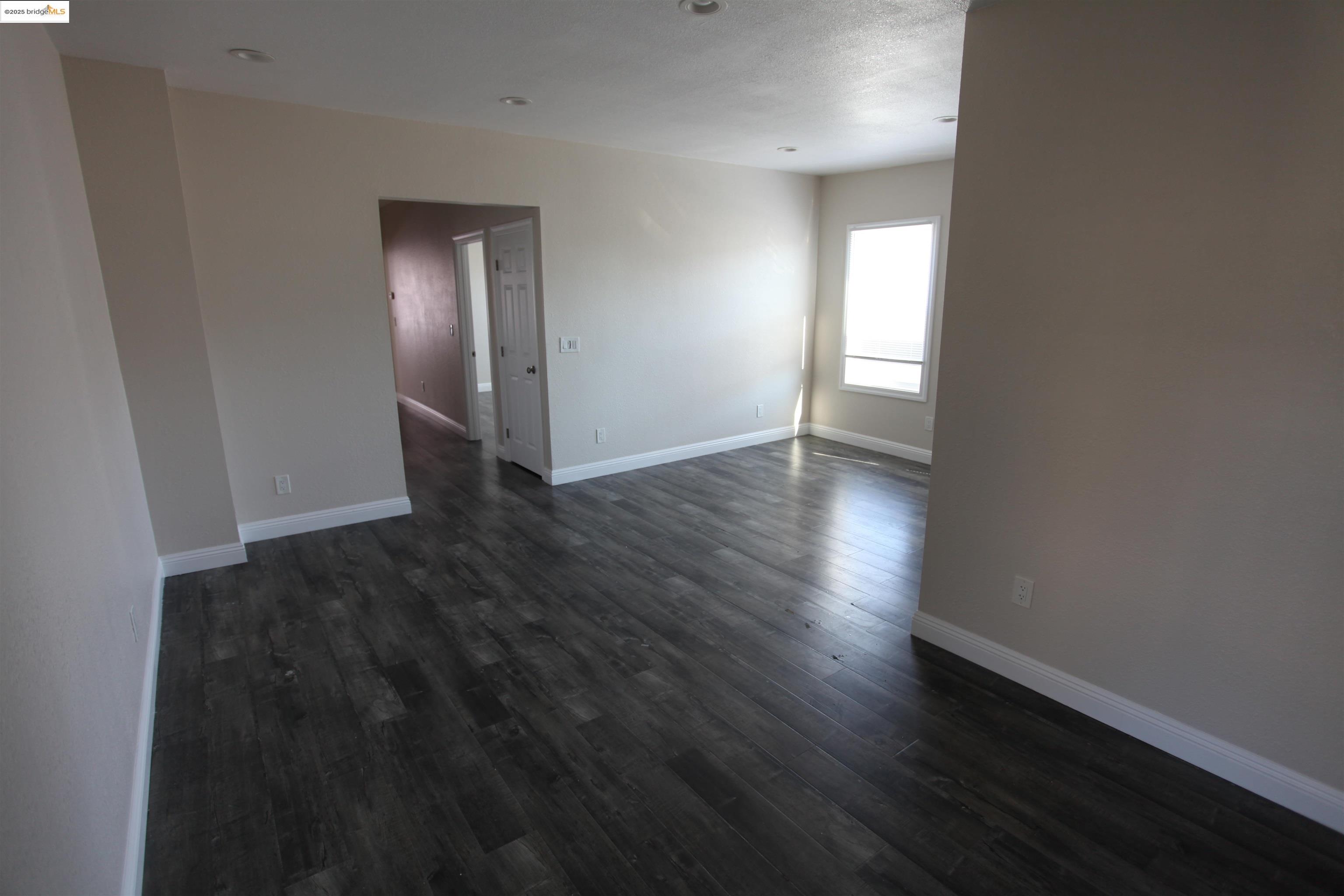 50 Main Street Isleton, CA 95641 - Photo 47 of 59 a view of an empty room with wooden floor and a window