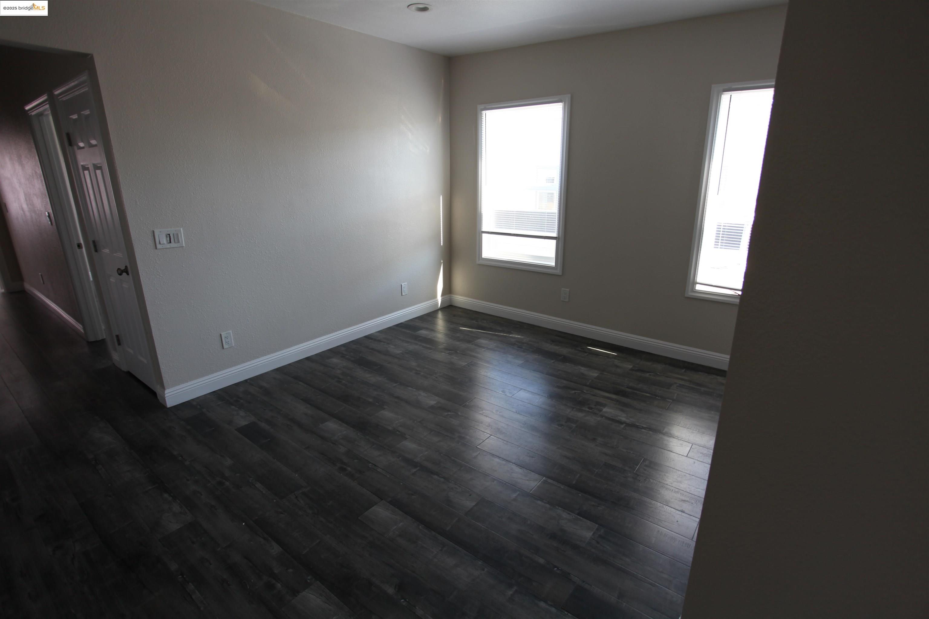 50 Main Street Isleton, CA 95641 - Photo 49 of 59 an empty room with wooden floor and windows