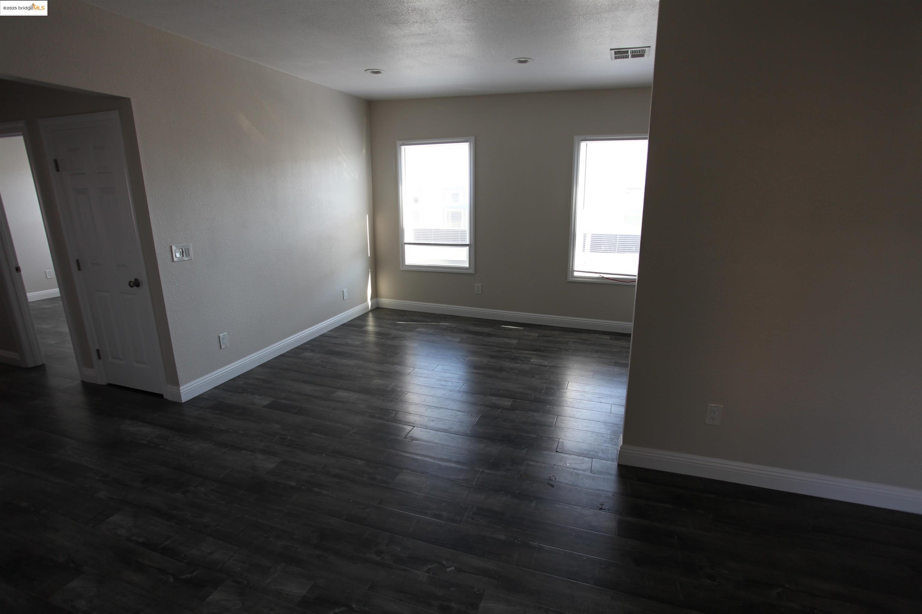 50 Main Street Isleton, CA 95641 - Photo 50 of 59 an empty room with wooden floor and windows