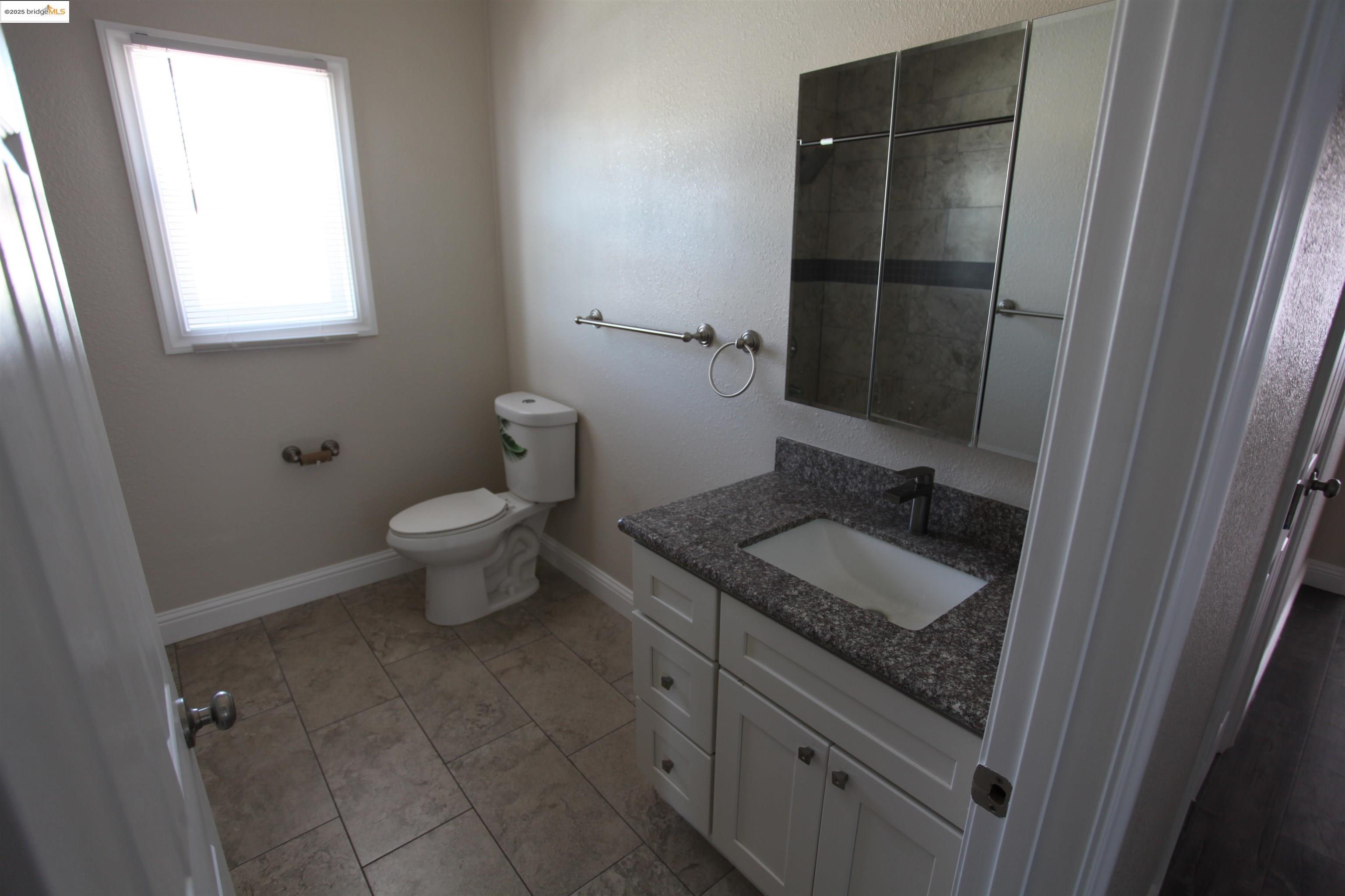 50 Main Street Isleton, CA 95641 - Photo 53 of 59 a bathroom with a granite countertop sink toilet and shower