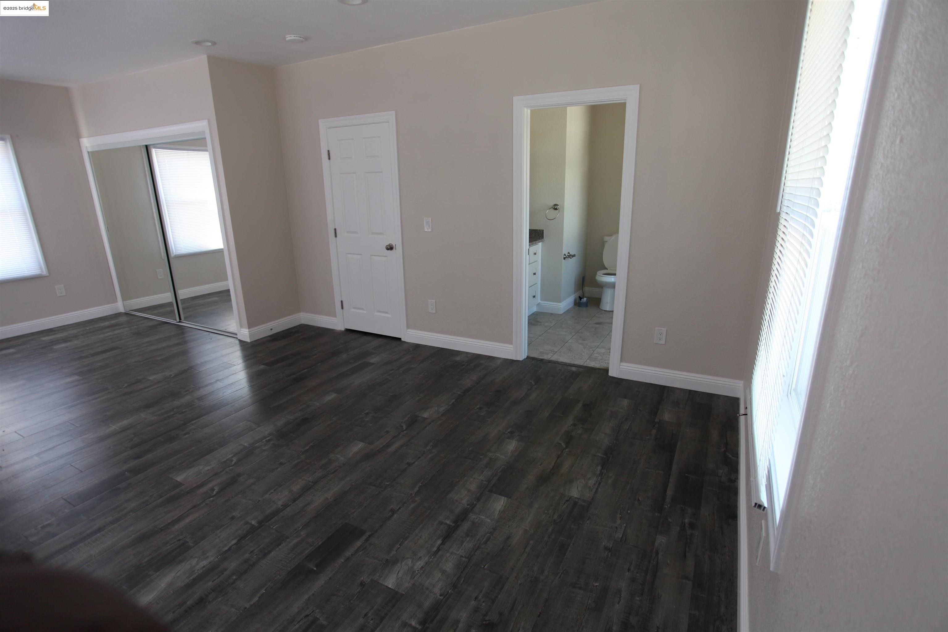 50 Main Street Isleton, CA 95641 - Photo 57 of 59 an empty room with wooden floor and closet