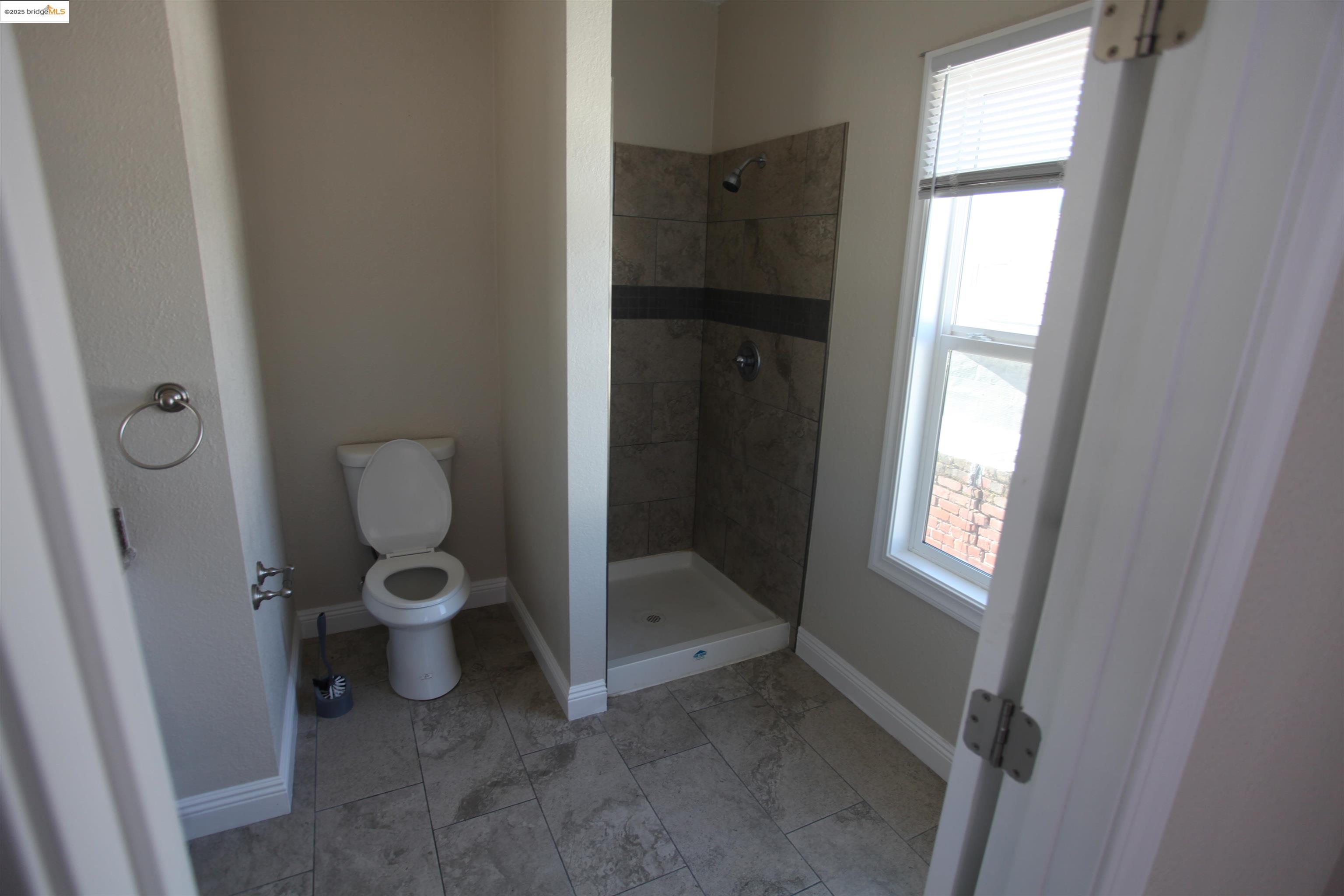 50 Main Street Isleton, CA 95641 - Photo 59 of 59 a bathroom with a toilet and a shower