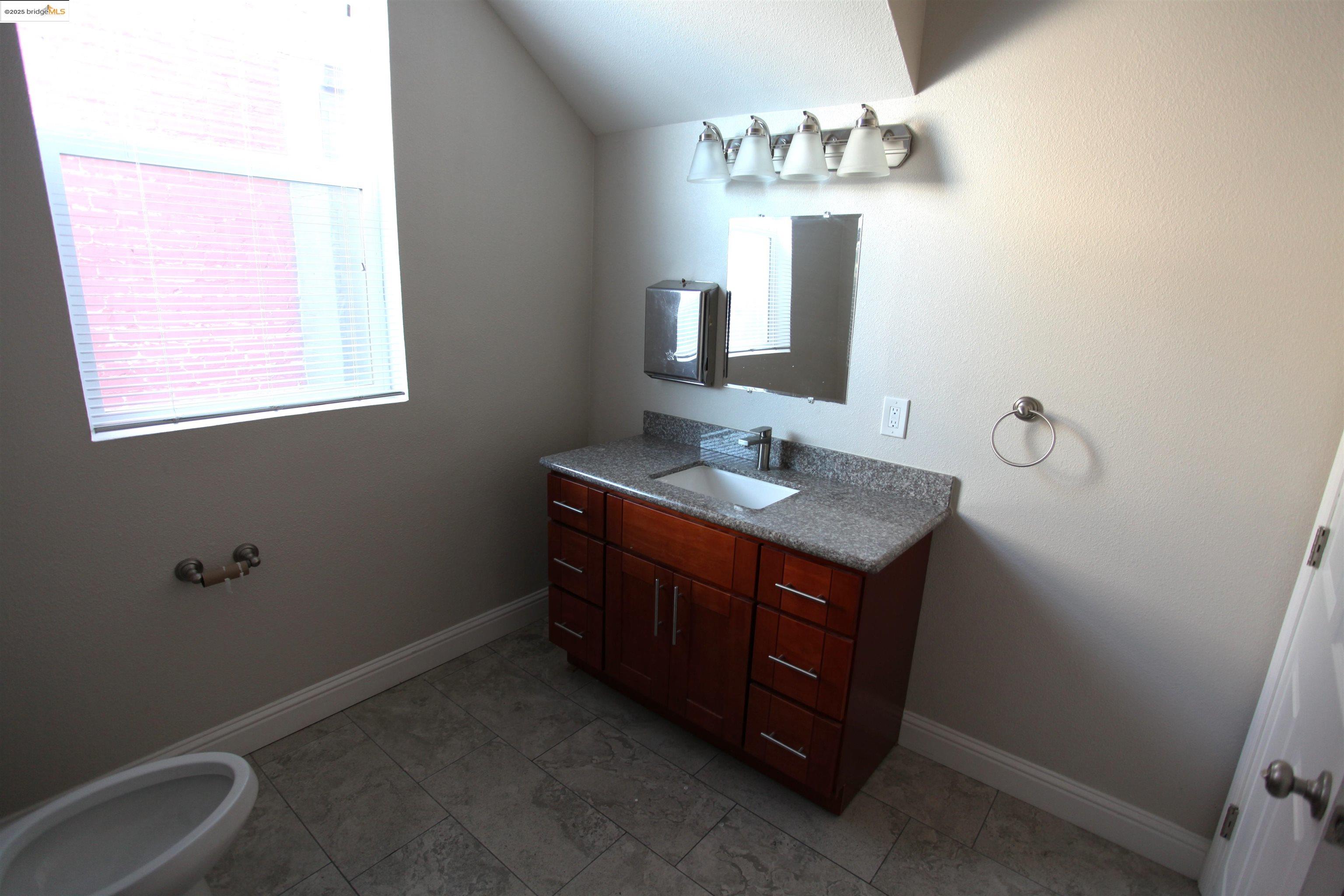 50 Main Street Isleton, CA 95641 - Photo 9 of 59 a bathroom with a double vanity sink and a mirror