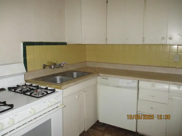 a kitchen with a sink and cabinets