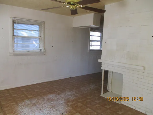 an empty room with windows and closet