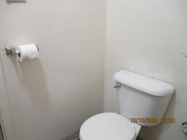 a white toilet sitting next to a shower