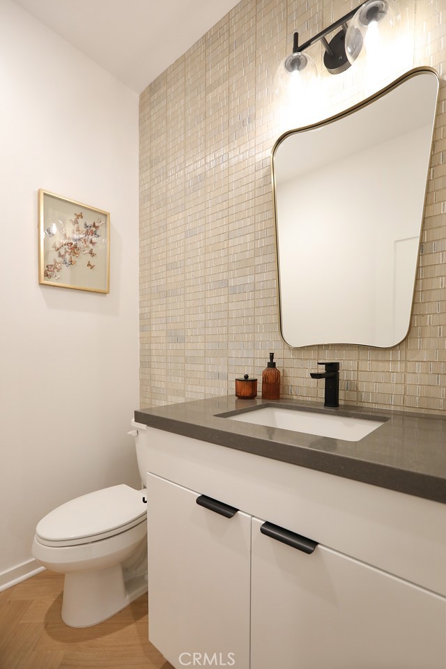 151 Jessup Way Tustin, CA 92780 - Photo 16 of 33 a bathroom with a granite countertop toilet sink and mirror