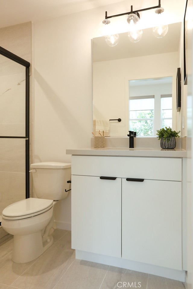 151 Jessup Way Tustin, CA 92780 - Photo 18 of 33 a bathroom with a sink a toilet a mirror and shower