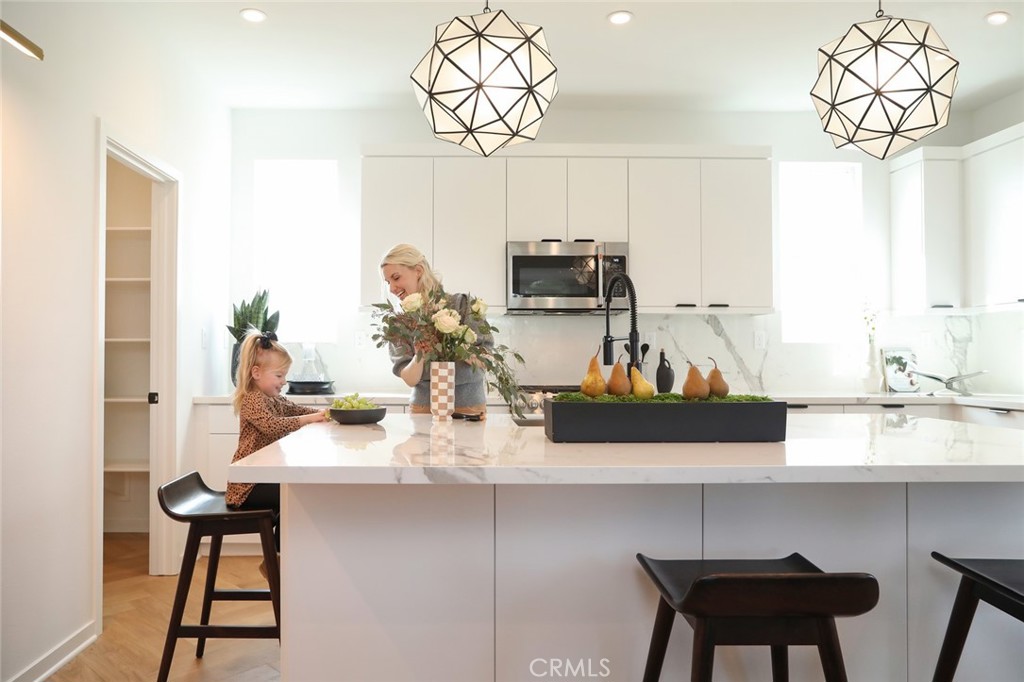 151 Jessup Way Tustin, CA 92780 - Photo 8 of 33 Kitchen island shown with designer pendant lights