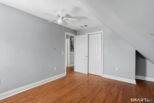 a view of an empty room with wooden floor