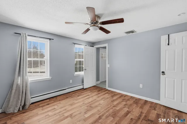 wooden floor in an empty room with a window