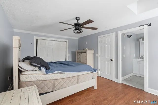 a bedroom with a bed and a chandelier