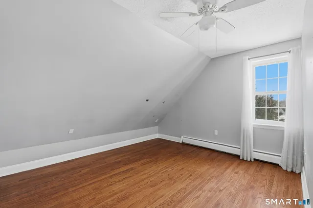 a view of a room with wooden floor and white walls
