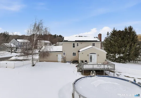 a view of a house with yard and sitting area