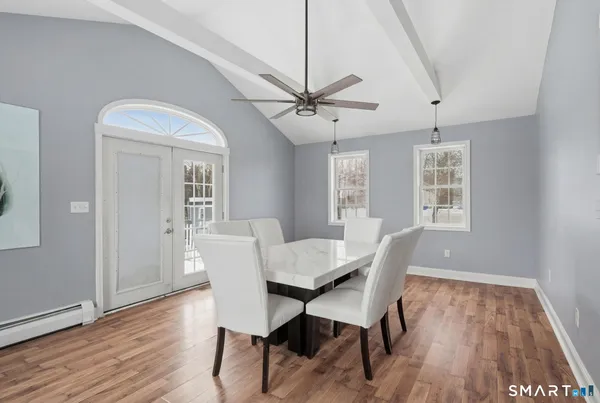 a view of a dining room with furniture window and wooden floor