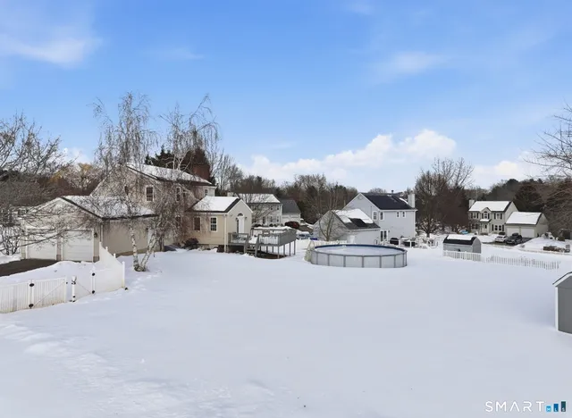 a view of a town with snow on the road