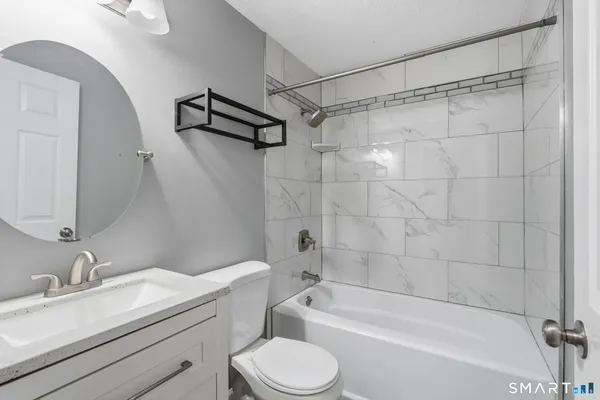 a bathroom with a sink a toilet and a bathtub