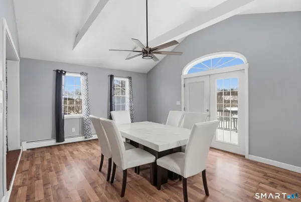 a view of a dining room with furniture window and wooden floor