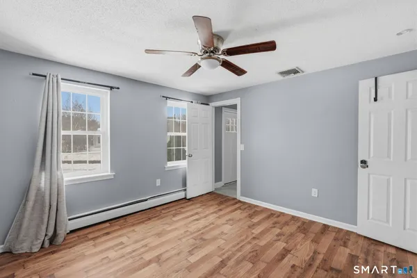 wooden floor in an empty room with a window