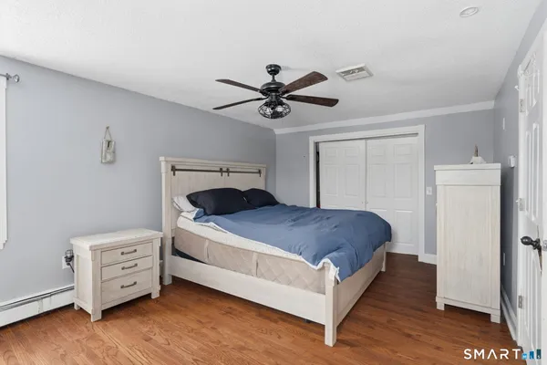 a bedroom with a bed and a ceiling fan